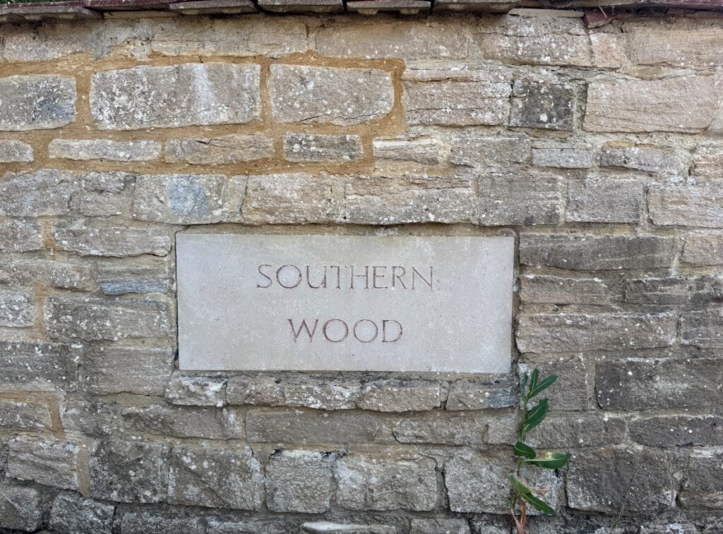 Southern Wood engraved stone sign on brick wall in Blisworth.