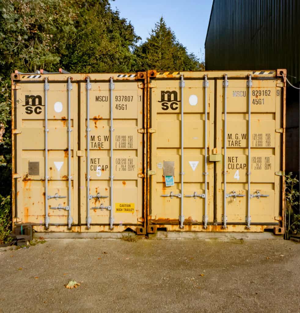 Two yellow shipping containers in Northampton for storage solutions.